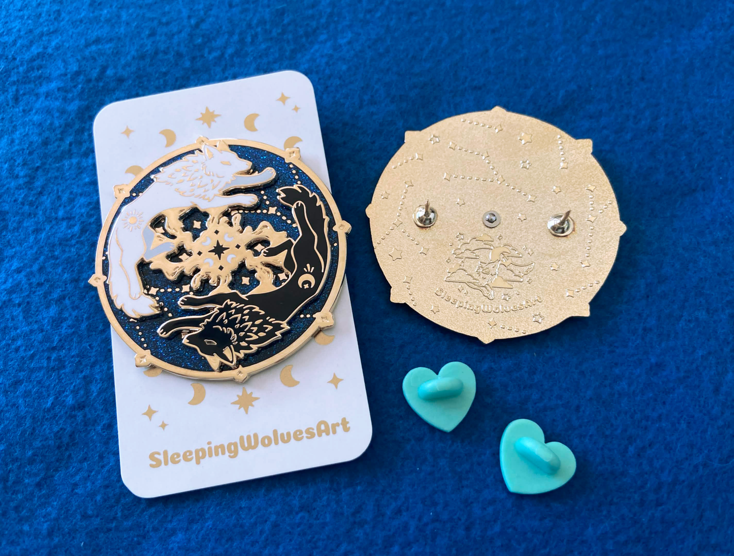 Gold and black wolf design on a card with blue heart-shaped objects on a blue background